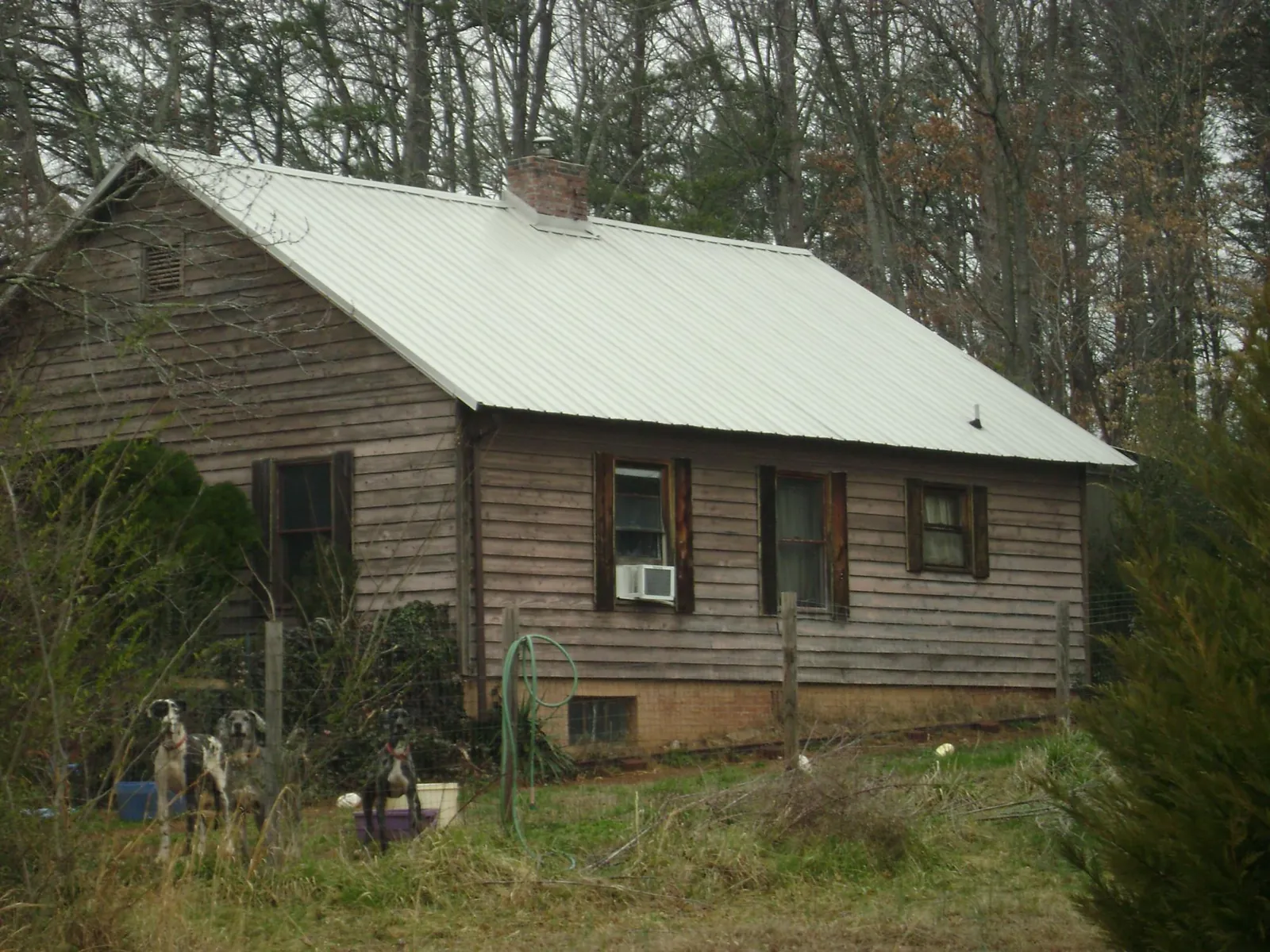 White metal roof on an old wood sided farmhouse, from a Metal Roof Installation job in Grand Meadow